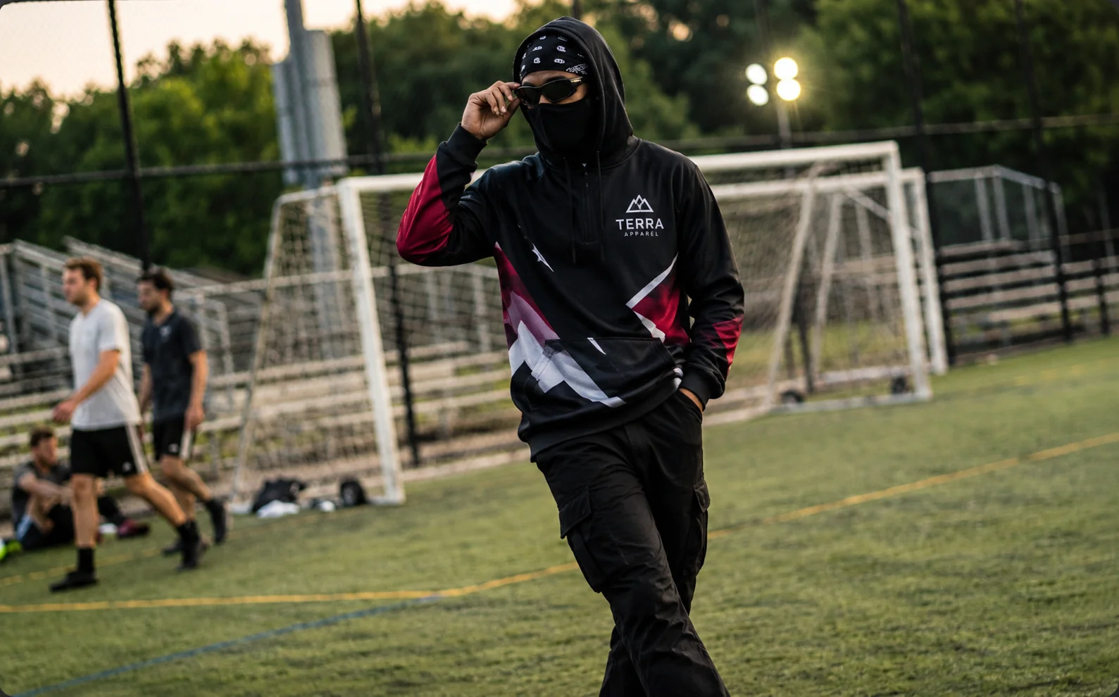 Masked Athlete on Turf at Dusk